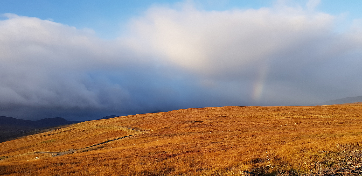 Bare hills and rainbows
